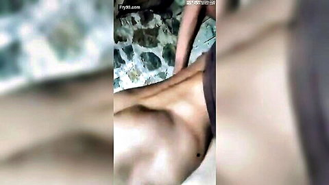 Nude Asian woman lying face down, hand on buttocks in intimate massage