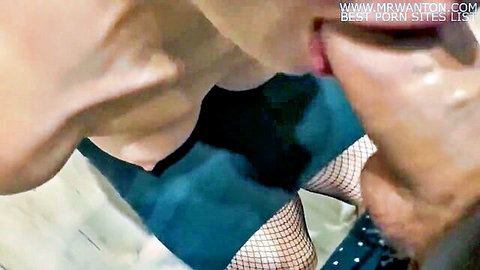 Woman in green dress and stockings performs oral sex close-up