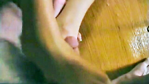 Barefoot with red toenails stroking hard erect cock in footjob closeup