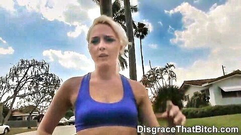 Blonde babe with small tits jogging in shiny blue sports bra by poolside palms, surprised look