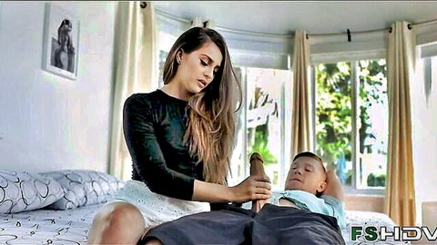 Brunette stepsis giving handjob to young stepbro on bed in taboo scene