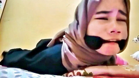Hijabi Indonesian woman gagged in BDSM bondage pose