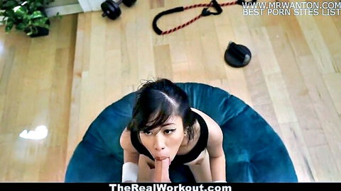 Fit Asian gym babe in black outfit seductively sucks fingers on blue pouf