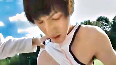 Hand pulling open Asian twink's white tank top exposing smooth bare chest outdoors