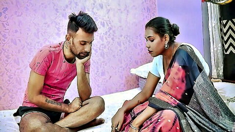 Indian MILF in saree sits intimately with tattooed boyfriend on bed