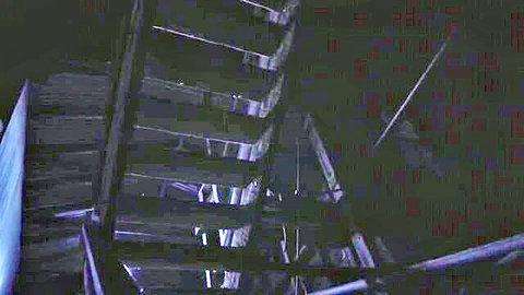 Casey Calvert and Charlotte Sartre in shadowy BDSM stairs scene