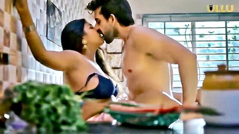 Indian couple passionate kitchen kiss, curvy woman in black bra