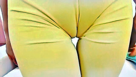 Close-up cameltoe stretch in tight yellow leggings for fisting