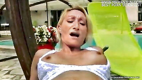 Blonde MILF cougar exposes huge tits and moans ecstatically on pool lounger