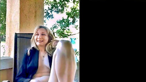 Blonde MILF smiles spreading legs wide on outdoor patio chair exposing shaved pussy