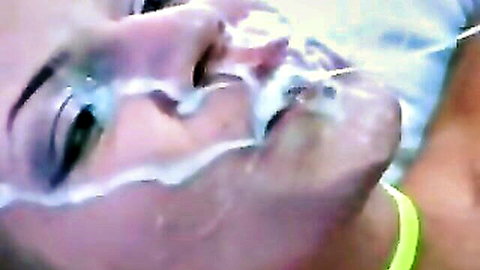 Close-up of brunette woman with facial cumshot on face and mouth
