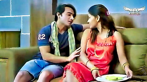 Desi owner lady in red dress intimate with servant boy on couch, web series scene