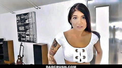 Tattooed brunette in revealing white cutout top teasing with surprised look on DadCrush