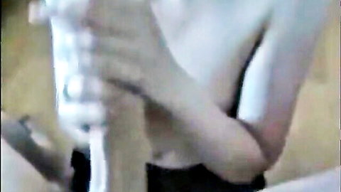 Close-up of pale-skinned woman giving intense handjob to massive cock