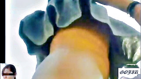Close-up of young woman's shaved pink pussy with blue shorts pulled aside exposing wet labia.
