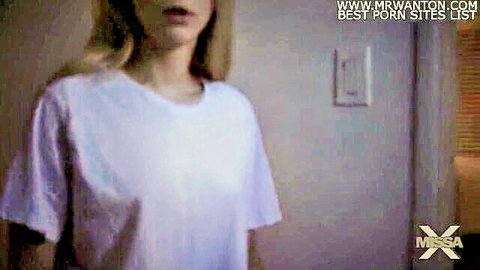Blonde woman in white t-shirt gazing intensely in MissaX Sister's Bad Date