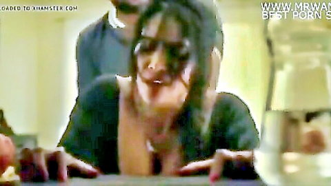 Seductive Indian Bhabhi in low-cut black top showing deep cleavage