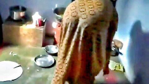 Desi bhabhi in orange saree teasing from behind in kitchen solo