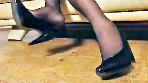 Woman's sheer nylon feet in black heels, teasing foot fetish close-up