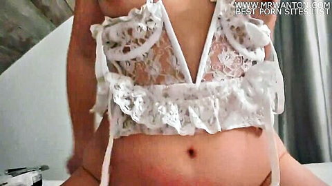 Curvy woman in white lace lingerie, teasing cleavage and belly