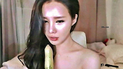 Korean webcam girl topless, simulating blowjob with banana toy