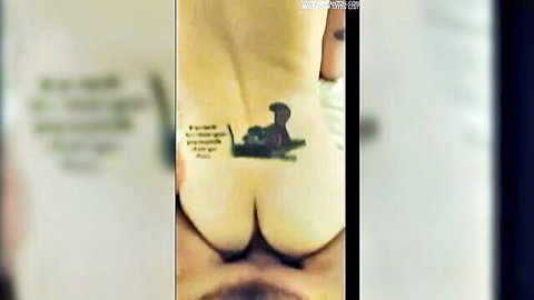 Redhead Ginger's tattooed butt in anal training close-up