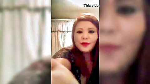Sexy redhead with plump red lips pouts seductively in sparkly black dress showing cleavage