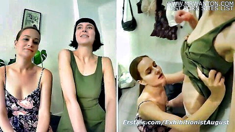 Two smirking lesbians in green dresses playfully lift top exposing perky tits indoors