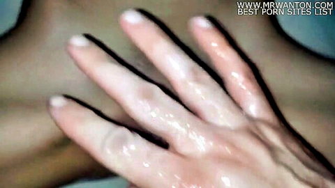 Woman's hand covered in thick sticky cum dripping from fingers after handjob