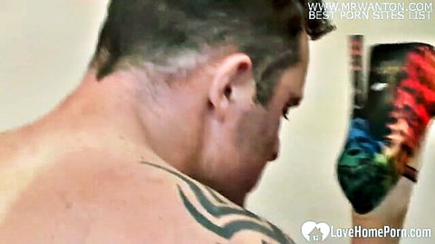 Muscular tattooed man holds colorful high heels in amateur MILF scene