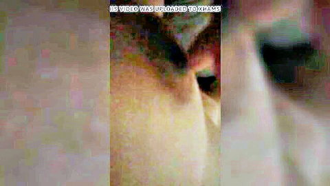 Blurry Southeast Asian woman in sensual pose with xHams watermark overlay