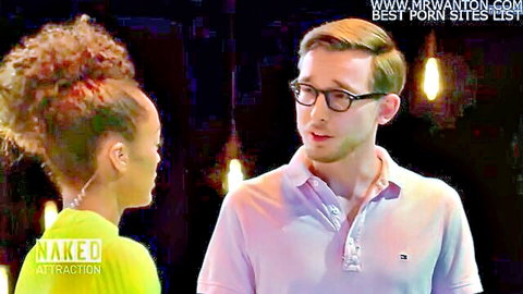 Curly-haired woman in yellow top chats with glasses-wearing man in Naked Attraction German dating show clip