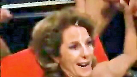Mature MILF with curly brown hair smiling in bukkake preview