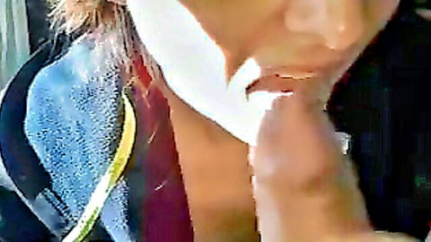 Blonde woman giving close-up blowjob with hand assistance