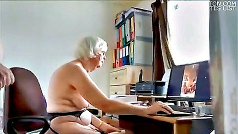 Elderly granny with huge saggy tits exposed types on computer naked from waist up