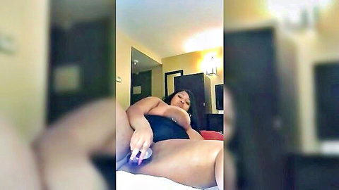 Ebony BBW with massive tits teases pussy with purple vibrator on hotel bed