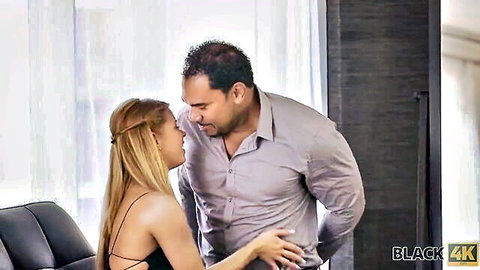 Petite blonde teen intimately kissing muscular stud with hand on his chest