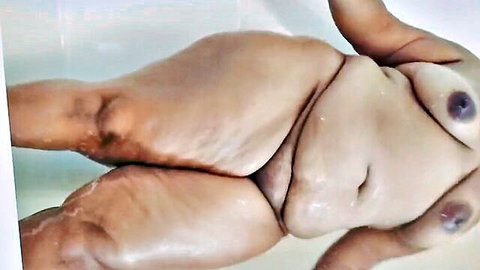 Curvy ebony BBW nude in bathtub, legs spread selfie