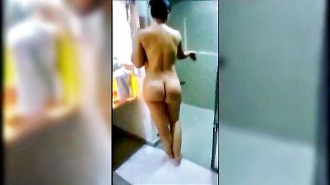 Nude Asian woman in shower, back view showcasing round ass