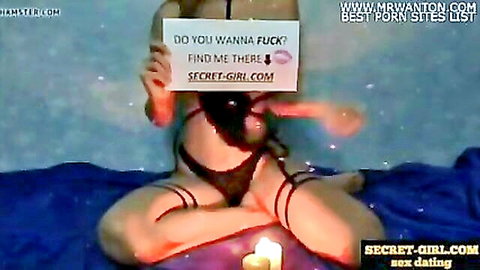 Sexy woman in black lingerie holds 'Do you wanna fuck?' sign, teasing online