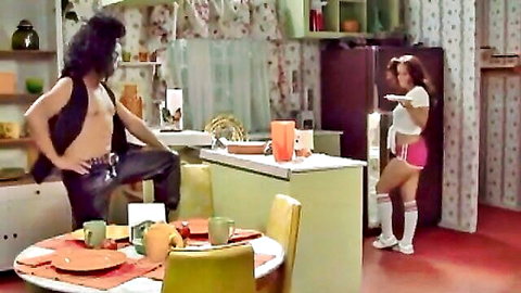 That 70s Show porn parody: Brunette in crop top, pink shorts, knee socks flirts with hairy hunk in vest