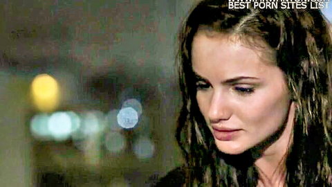 Intense close-up of brunette model Lily in moody Wasteland scene