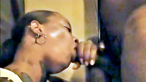 Ebony woman giving close-up blowjob with hand grip