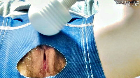 Hairy pussy exposed through ripped blue denim shorts with white ridged vibrator pressed on clit
