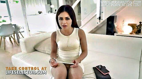 Martina Smeraldi in white tank top and handcuffs, legs spread on couch