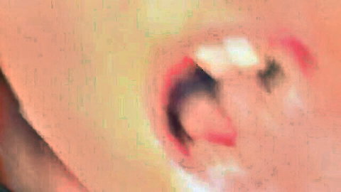 Close-up of open mouth in blowjob scene with blonde and brunette