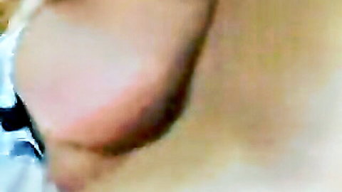 Close-up of blonde woman's ear and nude shoulder in intense adult scene