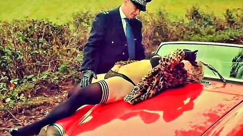 British policeman looms over leopard-clad babe in stockings and thong on red car hood