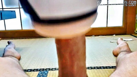 POV closeup of young Japanese man's huge erect cock next to white masturbator sleeve on tatami mat