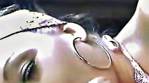 Seductive close-up of blonde's smoky eye and large hoop earrings glistening with lust